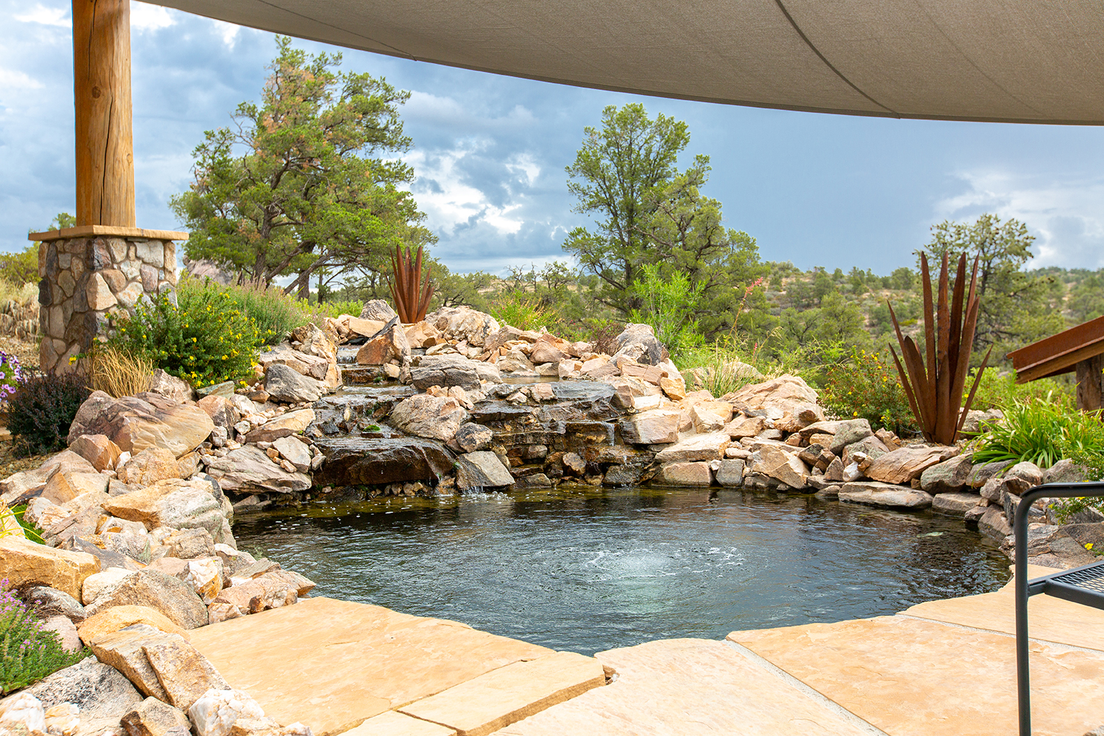 Pond with natural boulders and landscaping